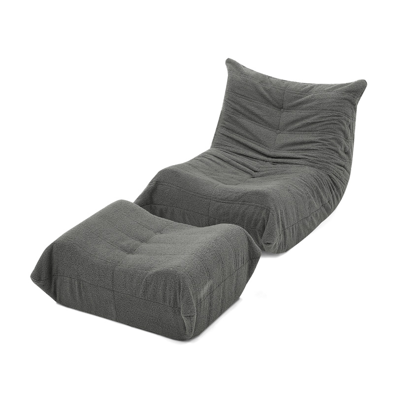 Fauteuil lounge gris en tissu effet teddy avec dossier et repose-pieds